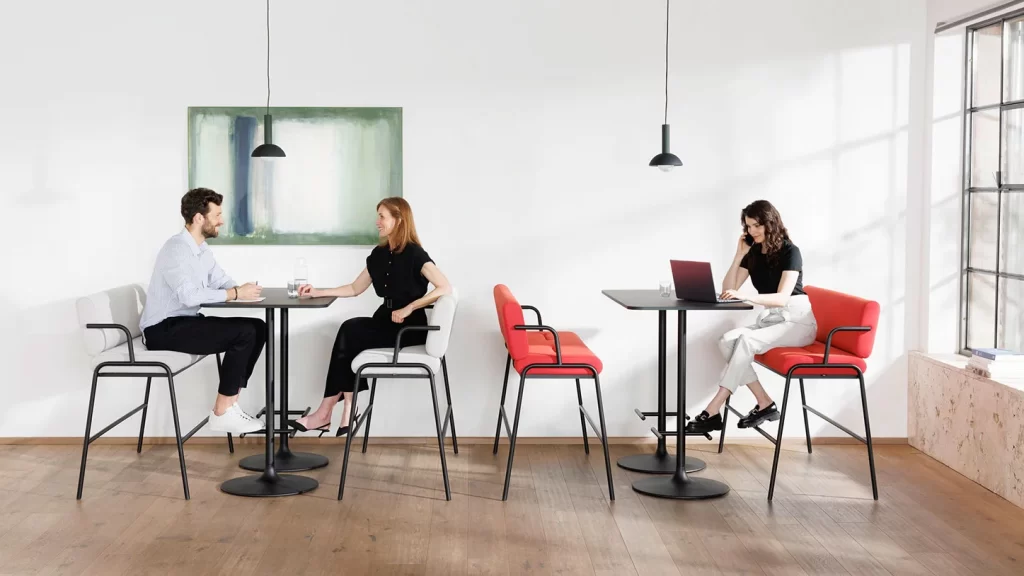 A picture of two people seating together at a Casual by Bene bench, next to another person using a single Casual by Bene bench, distributed by Walls to Workstations.