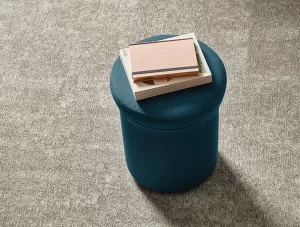 A picture of ShawContract New Path Collection - Poised Ecoworx S tile with a blue furniture and books on top.